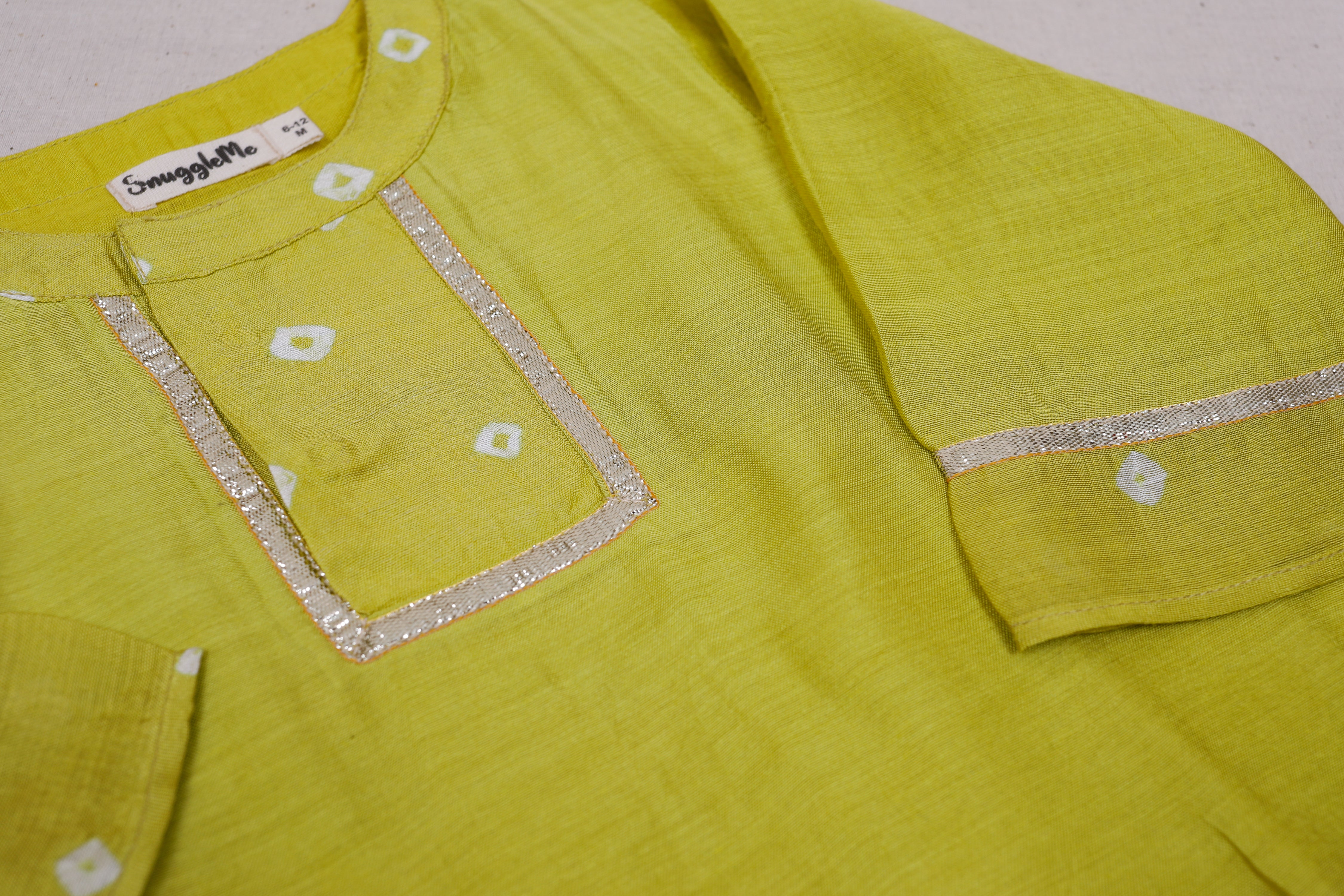 Infant boy in a lime green high low kurta top with pants.