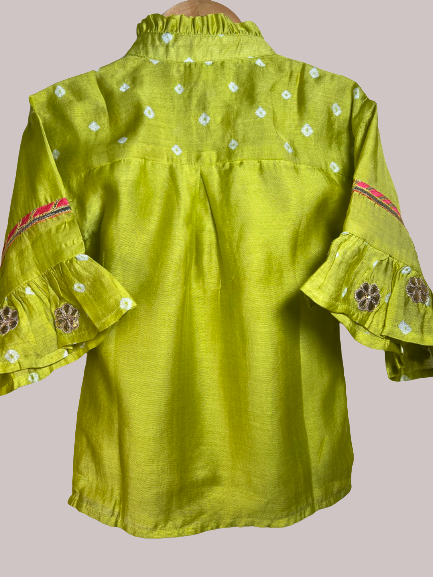 Little girl in a lime green vintage-inspired ethnic set