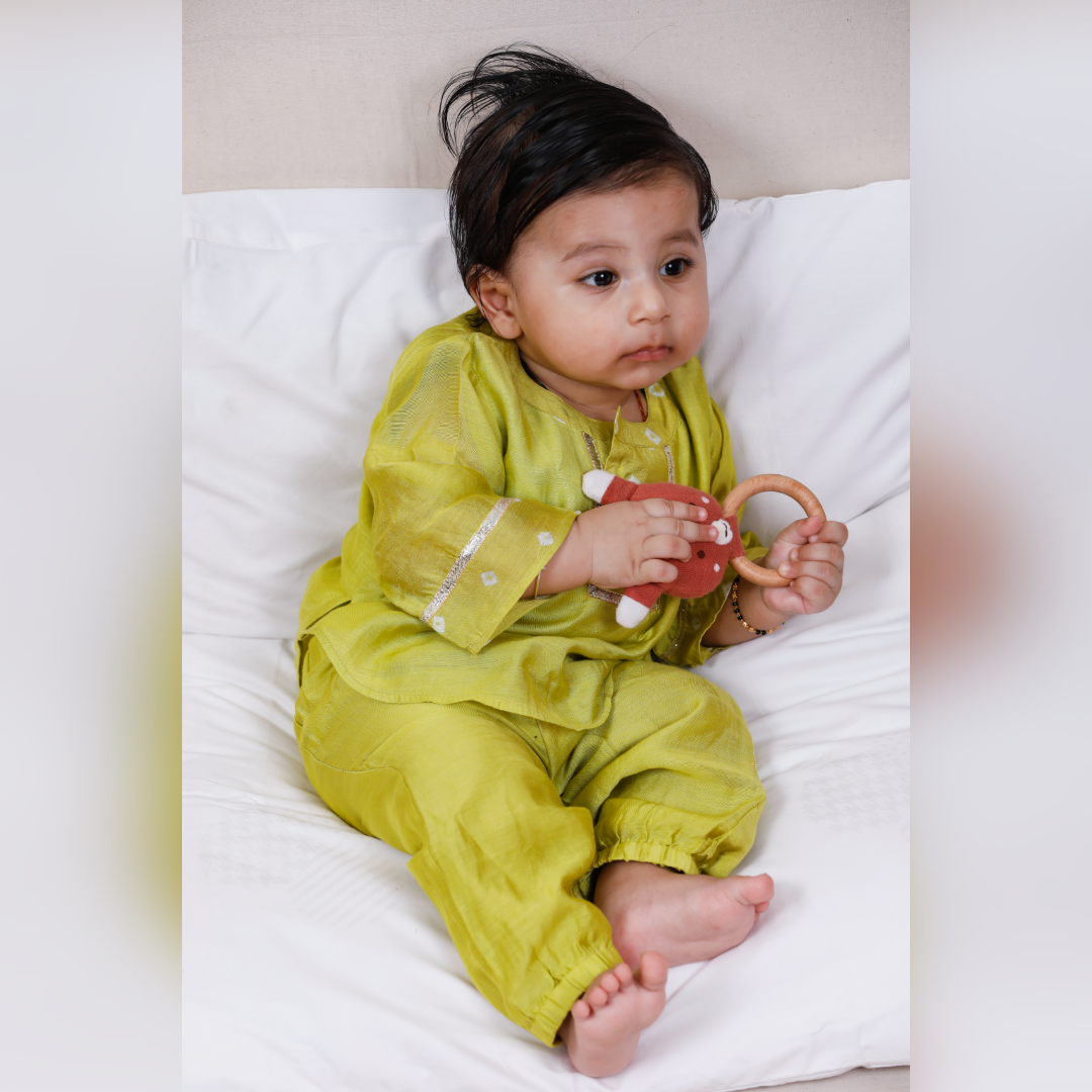 Infant boy in a lime green high low kurta top with pants.